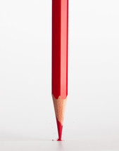 Broken tip of red pencil isolated on white background