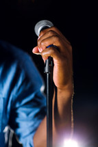 hand gripping a microphone 