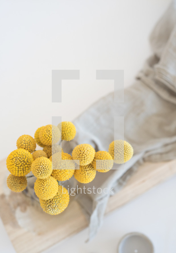 yellow flower balls and linen fabric 