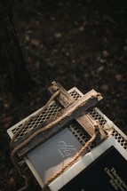 cross and Bible on a table at an outdoor wedding 