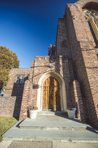 brick church with arched doors 