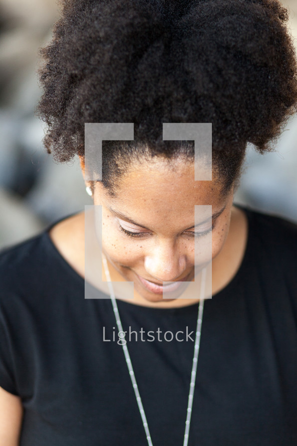 face of an African American woman looking down 