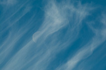moon behind wispy clouds