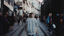 woman walking down a city sidewalk 