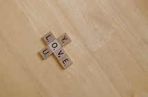"Love you" arranged in diagonal cross with scrabble letters.