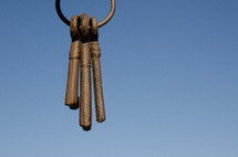 ring of old keys hanging in front of blue sky