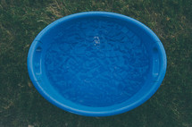 A blue plastic container of ice water.