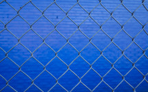 chain link fence and blue wall 