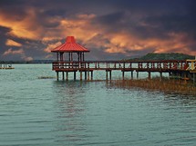 A gazebo at the end of a pier. 