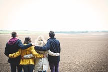 teens standing together in a field 