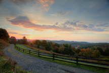 gravel road and fence line at sunset and fall colors 