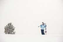 woman holding snow skis 