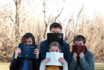 college students reading their Bibles outdoors during a Bible study