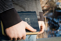 young man holding a Bible