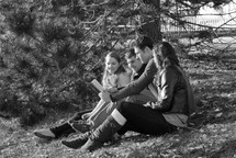 college students reading their Bibles outdoors during a Bible study