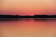lake under a pink sunset