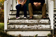 couple sitting on front steps 