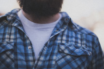 A man with a beard wearing a blue shirt