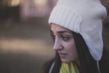 A young woman wearing a white beanie