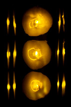 Three round yellow lights with reflections on each side.
