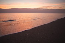 Ocean and beach at dusk.