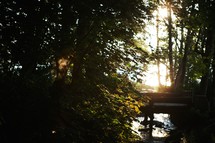 Bridge over a stream at sunset.