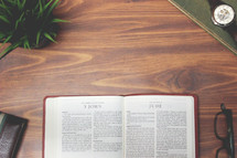 open Bible and reading glasses on a wood table - Jude 