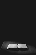 light on the pages of an open Bible