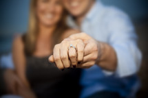 Couple showing engagement ring