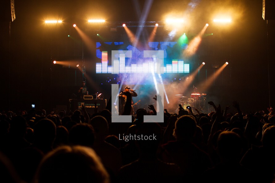 singer on stage at a concert under stage lights
