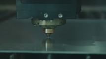 Slow motion of a laser cutting a metal plate