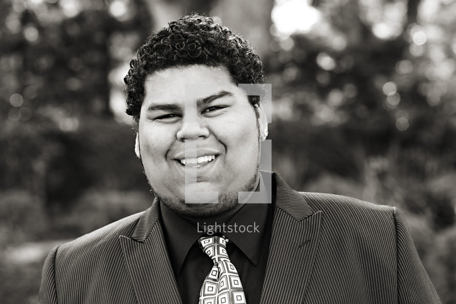 A smiling young man in a shirt and tie Samoan 