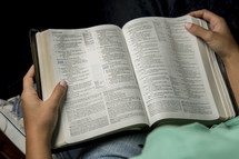 hands on a bible