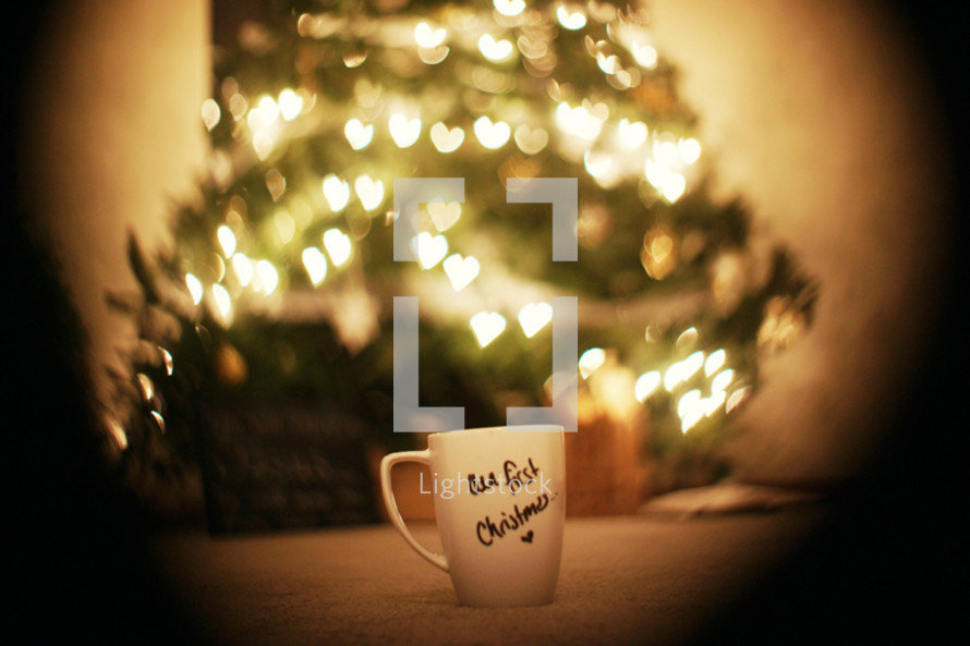 Christmas mug sitting in front of a tree