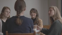 teen girls talking over coffee 