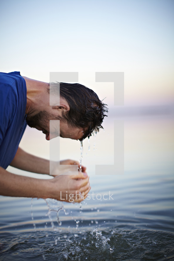 A man coming out of the baptismal waters