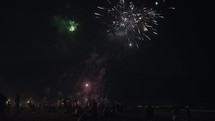New Year Eve Fireworks Display on Bali Beaches and Silhouette of People Celebrating it in Slow Motion