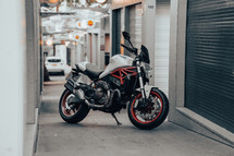 Ducati Monster 821 Italian motorcycle naked streetfighter white and red motorbike fast sports bike in an urban city setting