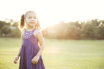 toddler girl standing outdoors enjoying summer