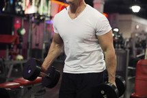 man lifting weights at the gym.