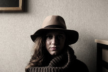 face of a woman under a hat 