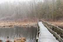 wood bridge over a pond 