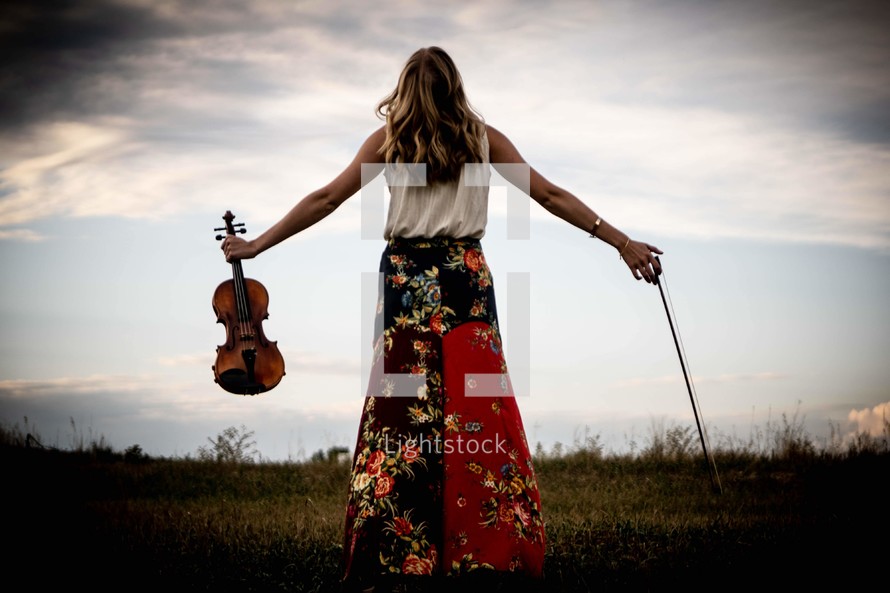 a woman holding a violin 