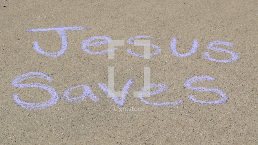 the words Jesus saves in sidewalk chalk 
