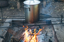 cooking a pot over the fire 