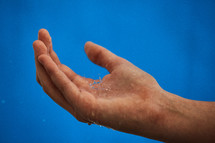 catching a water droplet in the palm of the hand 