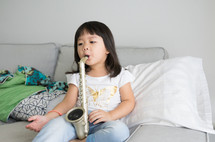 a child playing with a toy saxophone 