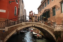 couple kissing on a bridge over a canal in Venice 