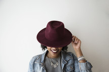 An African American woman wearing a hat 