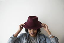 An African American woman wearing a hat 